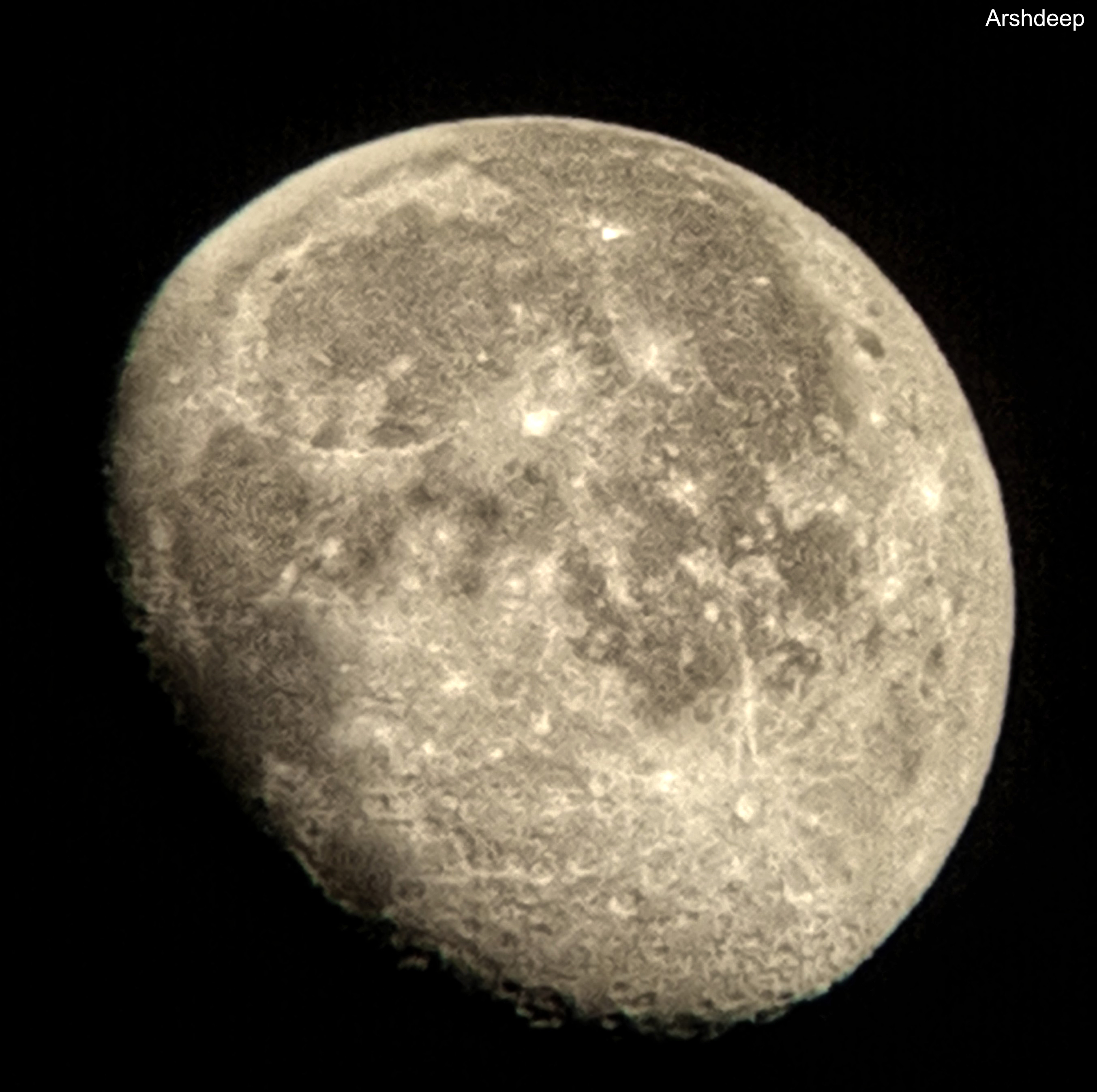 Close-up of the moon showing craters and surface texture against a black sky.
