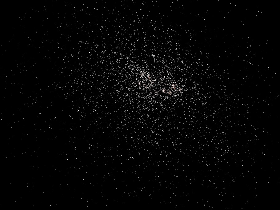 Dense star cluster captured against a black night sky.